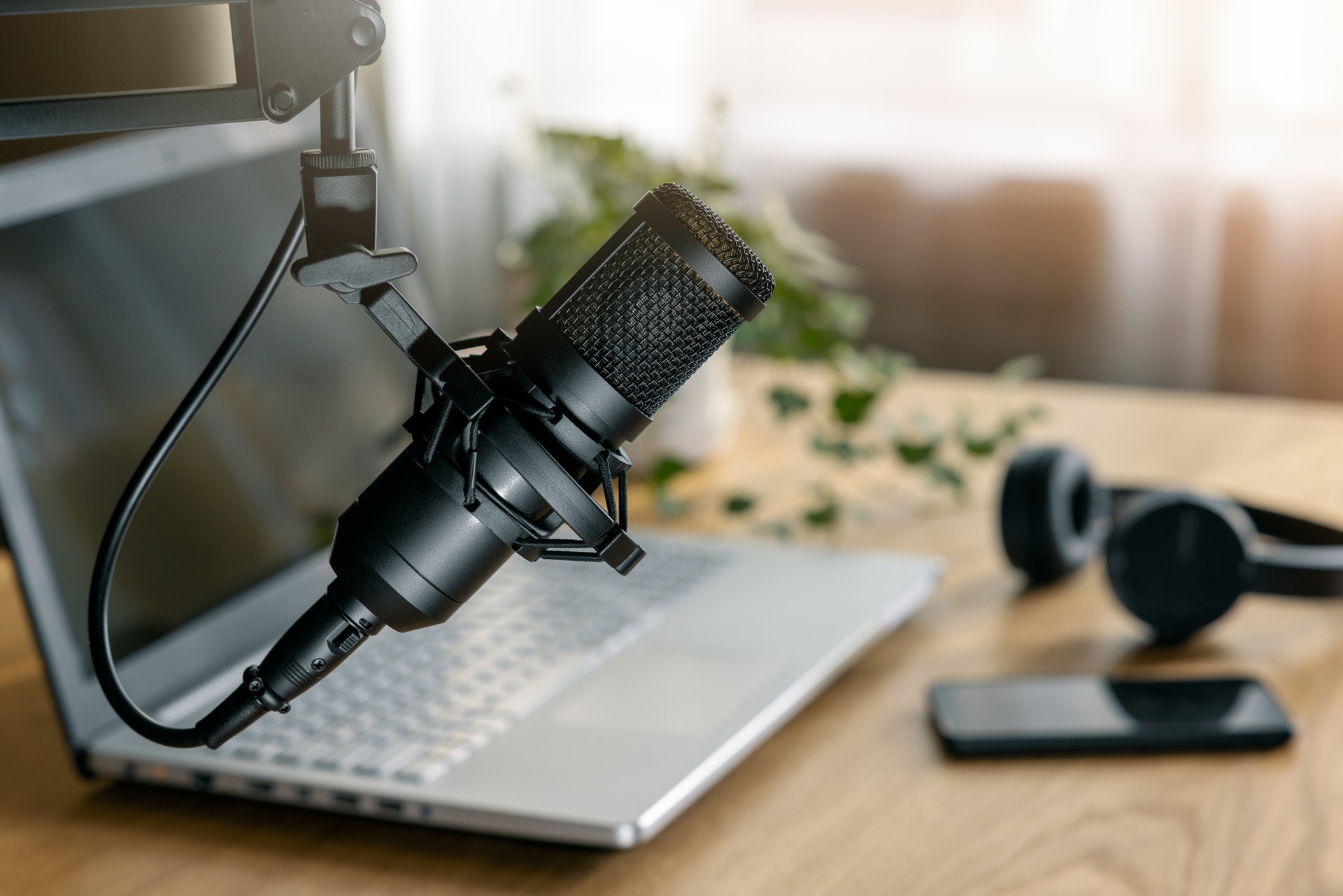 workplace of content creator. home studio for podcasting, online streaming, radio broadcasting. microphone closeup